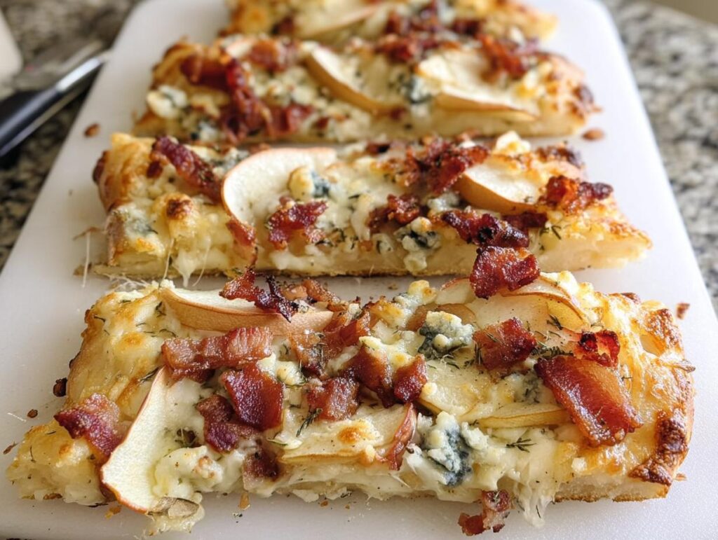Close-up of a slice of 10-ingredient pizza topped with crispy bacon, thin pear slices, and blue cheese.