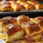 Close-up of baked ham and cheese sandwich ideas with poppy seeds and everything bagel seasoning.