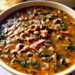 A close-up bowl of hearty black-eyed pea soup with ham and greens, part of The Ultimate Soup Recipes Guide for Beginners.