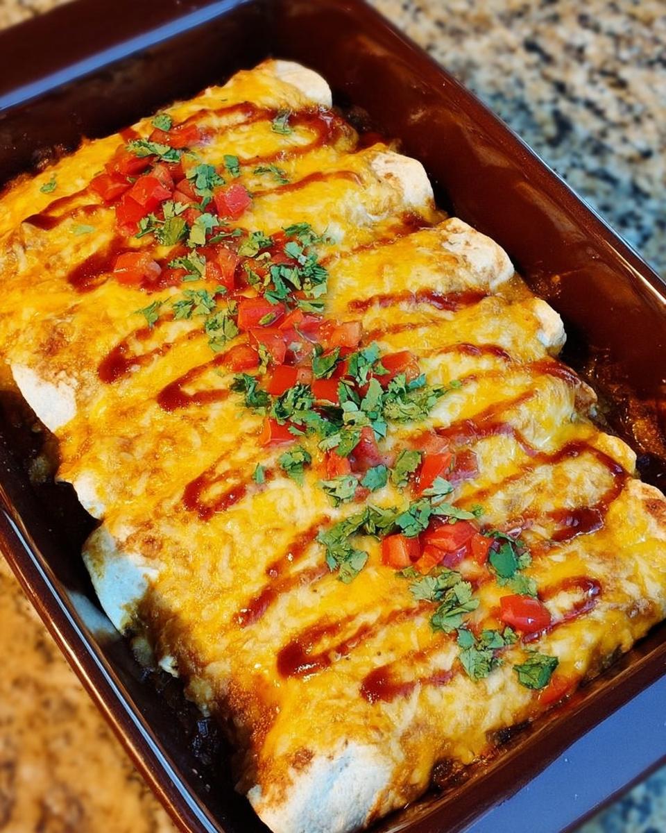 A pan of cheesy chicken enchiladas topped with diced tomatoes and cilantro, perfect for chicken recipes meal prep.