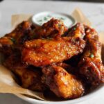 A bowl of glossy, glazed chicken wings, a perfect quick recipe for weeknights.