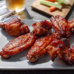 A plate of glossy, glazed chicken wings, perfect for a quick and satisfying meal.