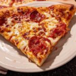 A delicious slice of pepperoni pizza with melted cheese, perfect for pizza night recipes.