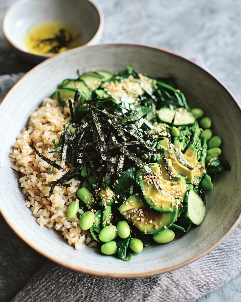 A vibrant rice bowl featuring brown rice, sliced avocado, edamame, cucumber, and nori, part of The Ultimate Rice Bowls Recipes Guide.