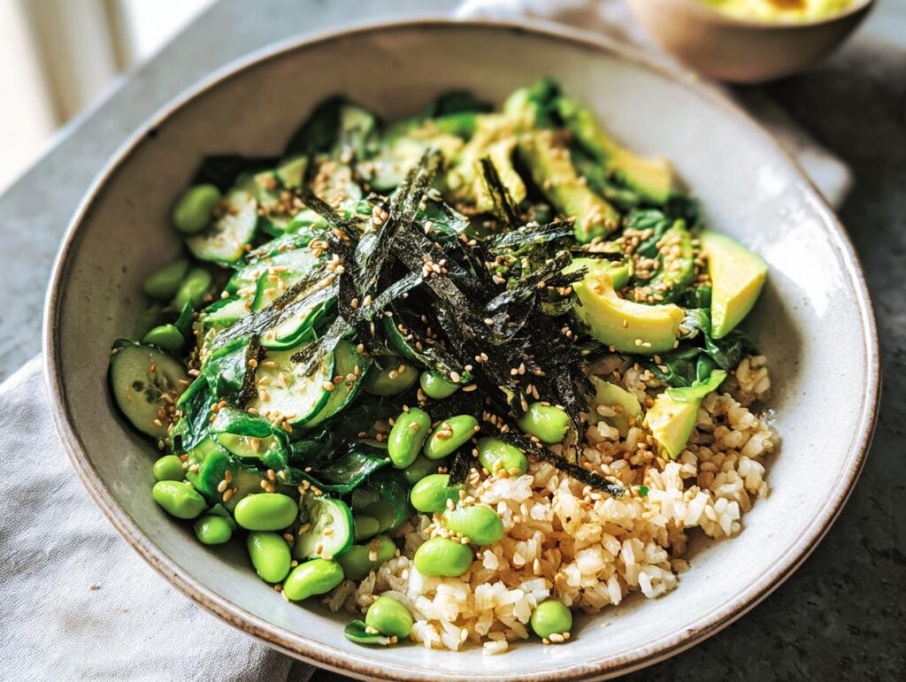 A vibrant rice bowl featuring brown rice, sliced avocado, edamame, cucumber, and nori, part of The Ultimate Rice Bowls Recipes Guide.