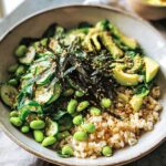 A vibrant rice bowl featuring brown rice, sliced avocado, edamame, cucumber, and nori, part of The Ultimate Rice Bowls Recipes Guide.