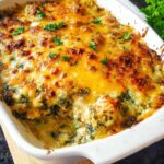 Close-up of a bubbling Creamy Low Carb Chicken Casserole topped with golden melted cheese and fresh parsley.