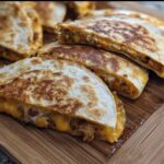 Golden brown slices of High-Protein Chicken Ranch Quesadilla filled with melted cheese and seasoned chicken.