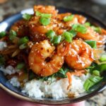 Close-up of Irresistible Honey Garlic Shrimp Bowls with rice, vegetables, and garnished with green onions and sesame seeds.