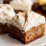 Close-up of a square Banana Bread Brownie Made Easy, topped with creamy frosting and a dusting of cinnamon.