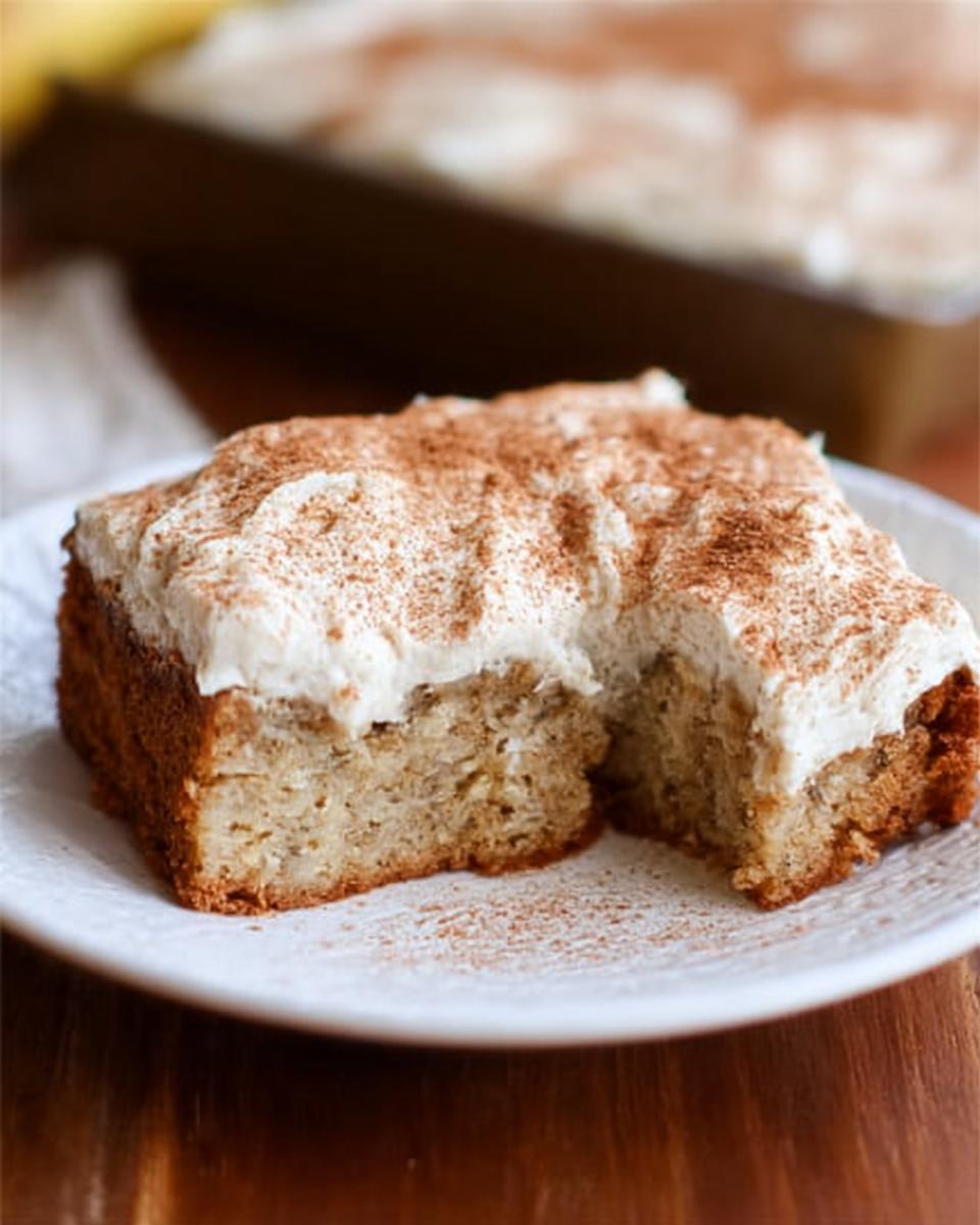 A slice of Banana Bread Brownies Made Easy, topped with creamy frosting and dusted with cinnamon.