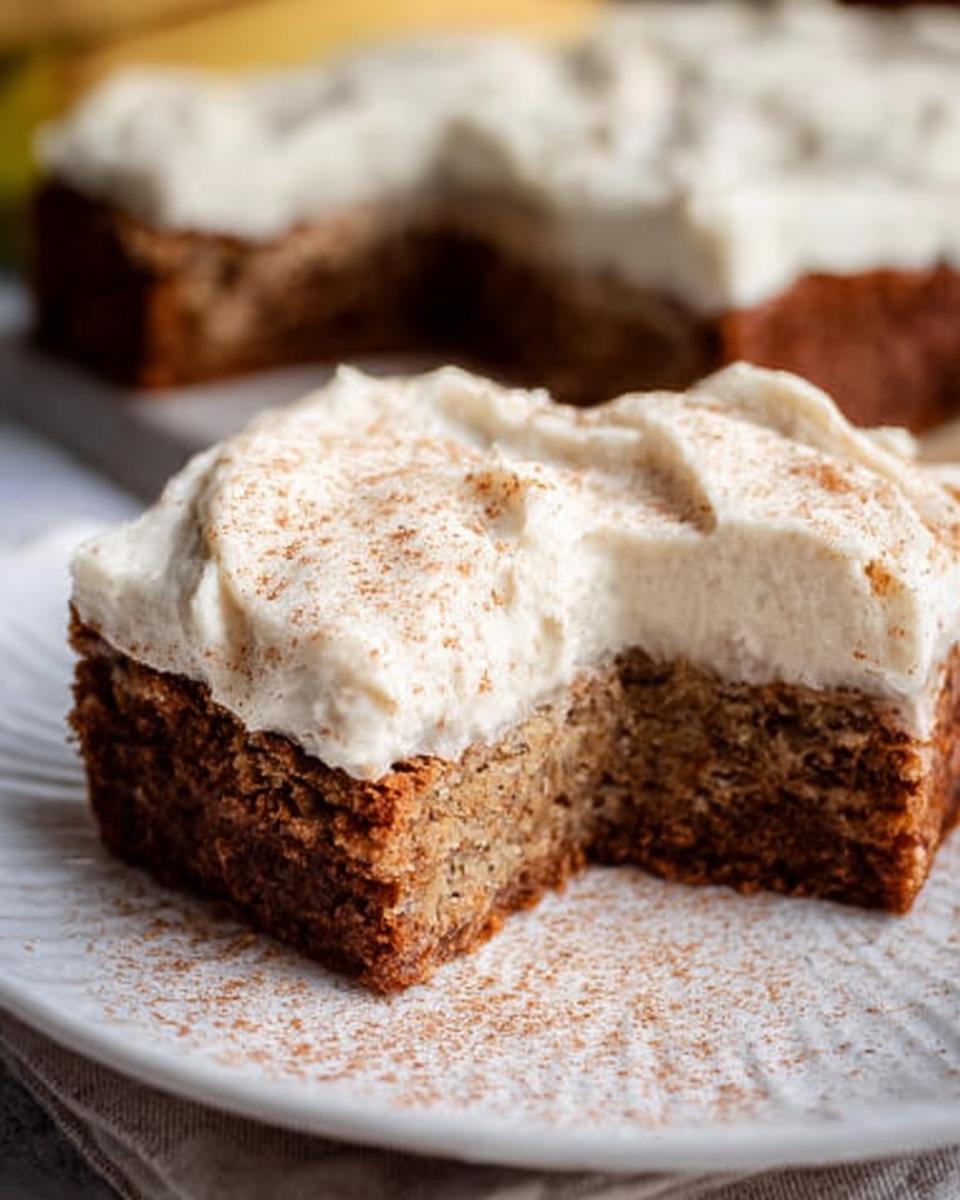 A slice of Banana Bread Brownies Made Easy, topped with creamy frosting and a sprinkle of cinnamon.