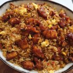 A close-up of a bowl filled with savory BBQ Chicken and Rice, featuring tender chicken pieces and fluffy rice.