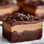 A close-up of a rich Chocolate Mousse Brownie slice, featuring a dense brownie base, creamy mousse layer, chocolate ganache, and chocolate shavings.