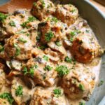 Close-up of delicious Creamy Mushroom Chicken Meatballs bathed in a rich, creamy mushroom sauce and garnished with fresh parsley.