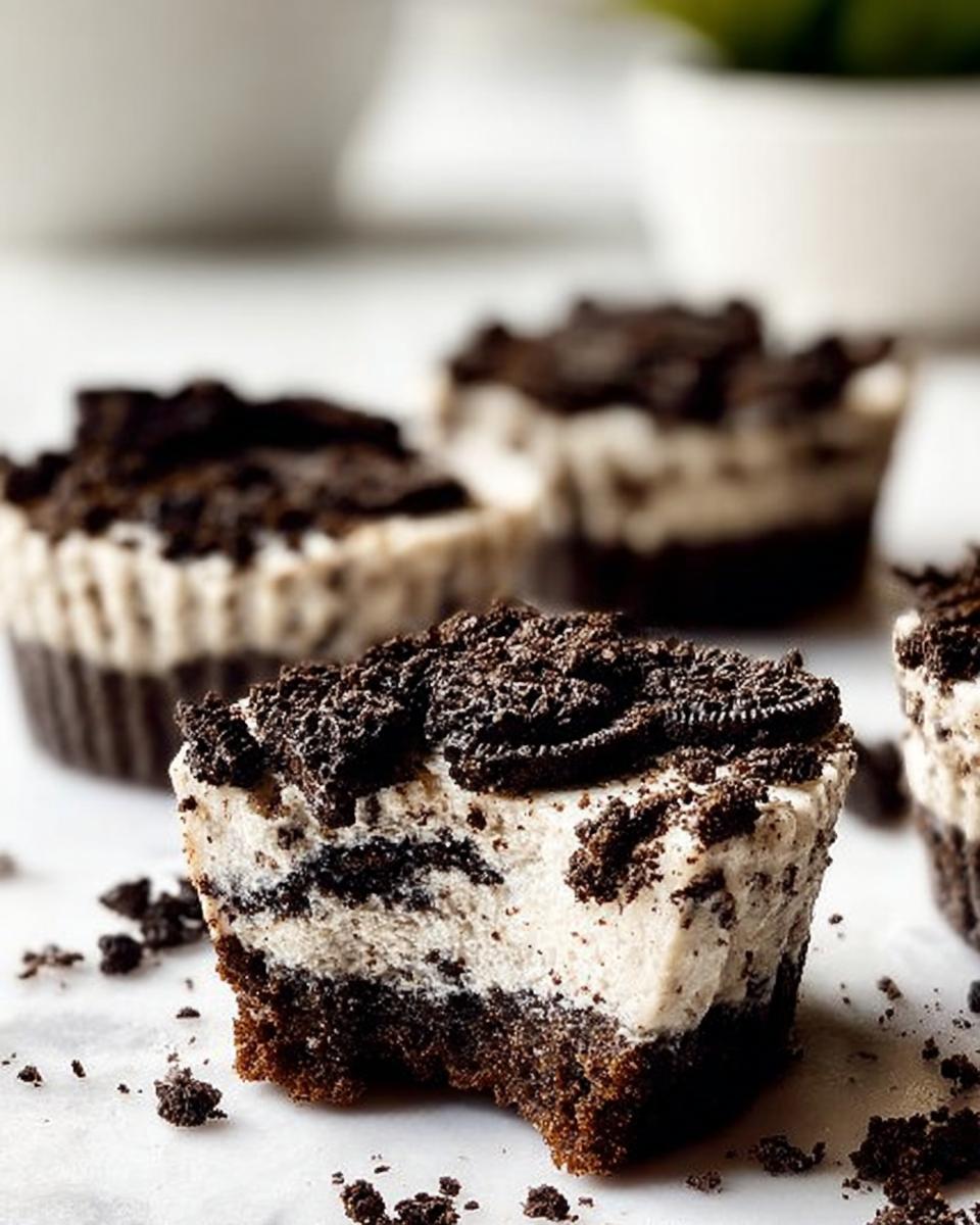 A close-up of a Healthy No-Bake Oreo Cheesecake Bite, showing the creamy filling and chocolate cookie crust.