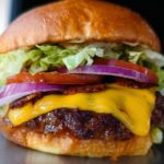 Close-up of an irresistible smash burger with melted cheese, lettuce, tomato, onion, and crispy bacon.
