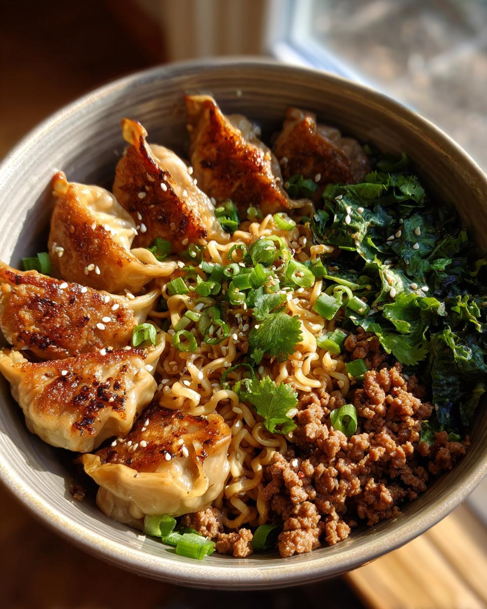 A close-up of a Potsticker Noodle Bowl with pan-fried potstickers, noodles, ground pork, and cabbage slaw.
